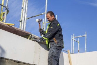 Bricklayer works on a new detached house