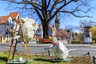 Funny Easter decoration with chickens at Wettinplatz, in the background the New Church Peter and