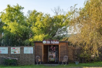 Wooden hut with a vending machine for sausage and cheese in a 24-hour farm shop, village of Rieben