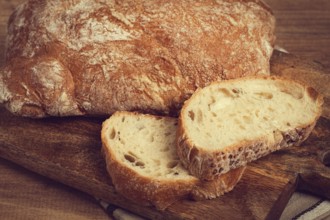 Sliced ciabatta, on a chopping board, italian bread, close-up, Italian cuisine, breakfast, no