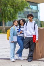 Vertical portrait of three multiracial university exchange students standing in the campus