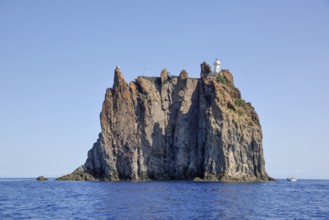 Rock island Strombolicchio with lighthouse, near island Stromboli, Lipari Islands, Tyrrhenian Sea,