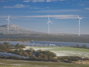Solar park and wind farm near Breuna, with hoarfrost covered woodland in the background, North