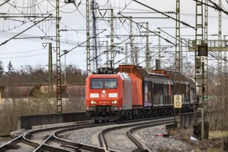 Goods train travelling on the winding Schuster Railway, overhead lines and infrastructure.