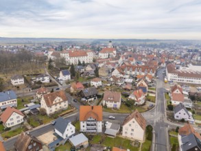 Overview of a charming town with a dominant church tower in the middle of a quiet neighbourhood,