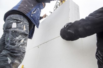 Bricklayers work on a new detached house
