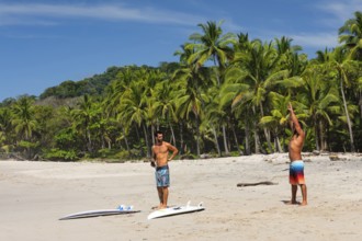 Surfers warming up on the beach of Santa Teresa, Nicoya Peninsula, Guanacaste, Costa Rica, Central