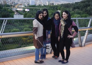 Women take selfie photos of themselves on the Tabiat Bridge in Tehran, Iran. The 270-metre-long