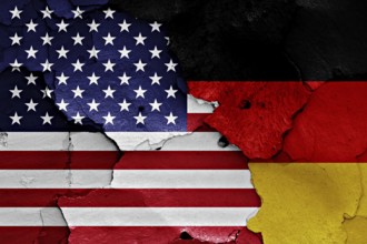 Flags of United States and Germany painted on cracked wall