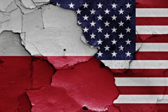 Flags of Poland and USA painted on cracked wall