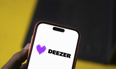 deezer logo is displayed on smartphone. Deezer is a French music streaming service