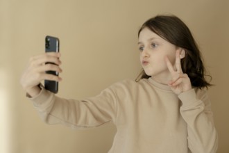 Girl, 10, takes a selfie with mobile phone
