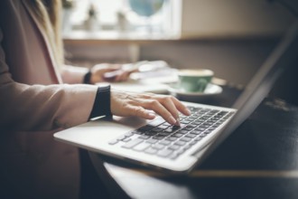 Close-up top view of Caucasian woman's hands Casually dressed student, blogger, writer man working