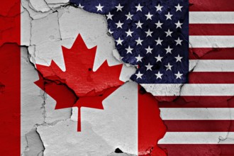Flags of Canada and USA painted on cracked wall