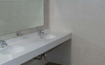 Closeup of double sink and mirror in public restroom in South Korea