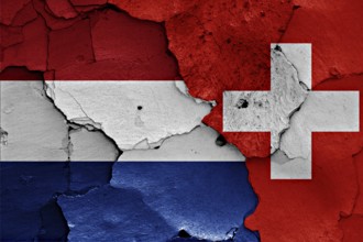 Flags of Netherlands and Switzerland painted on cracked wall