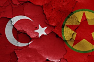 Flags of Turkey and PKK painted on cracked wall