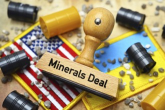 Stamp with inscription Minerals Deal on the flags of the USA and Ukraine with barrels and stones,