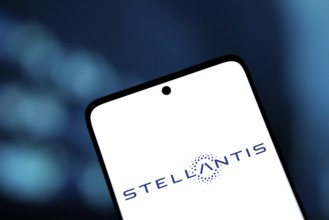 Stellantis logo is displayed on smartphone. Stellantis is a multinational automotive manufacturing