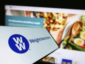 Stuttgart, Germany, 03-19-2023: Mobile phone with logo of WW International Inc. (Weight Watchers)