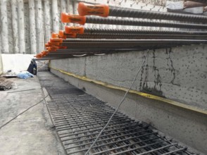 Close-up of reinforcement bars and concrete at a construction site