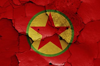 Flag of PKK painted on cracked wall