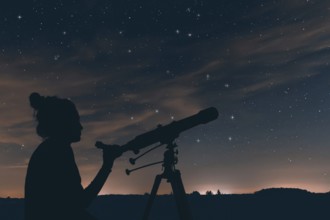 Woman with astronomical telescope. Night sky, with clouds and constellations, Hercules, Draco, Ursa