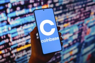 In this photo illustration, the Coinbase logo is displayed on a smartphone screen