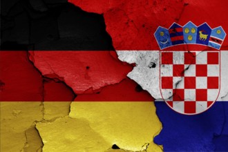 Flags of Germany and Croatia painted on cracked wall