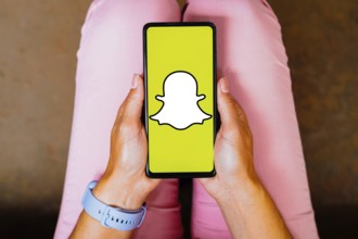 In this photo illustration, the Snapchat logo is displayed on a smartphone screen