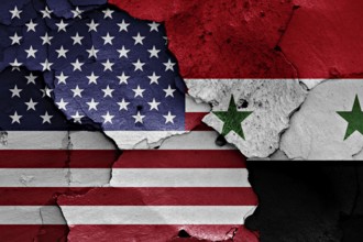 Flags of USA and Syria painted on cracked wall