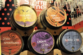 Madrid, Spain, Europe, wooden barrels with colourful painting and price indications in an interior,
