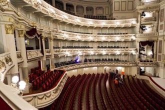 Semperoper, Dresden, Saxony, Germany, Europe, Large opera hall with red empty rows of seats,