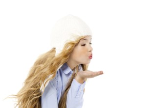 Beautiful winter kid girl blowing wind with lips isolated on white