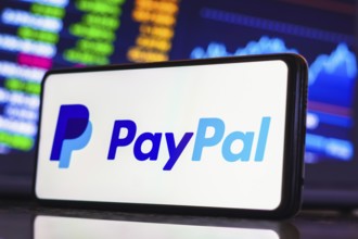 In this photo illustration, the PayPal logo is displayed on a smartphone screen