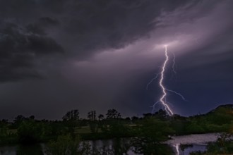 Illuminating lightning strikes the night sky over a landscape, Bogen, Lower Bavaria