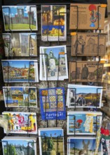 Display rack of colour picture postcards outside shop, city of Guimaraes, northern Portugal
