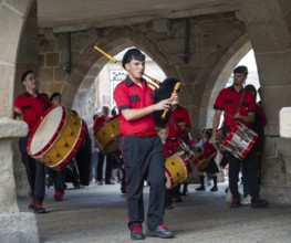 Traditional drum and pipe band perform on city streets on May Day 2025, Guimaraes, Braga district,