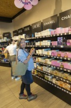 Woman shopping for perfume, Porto Duty Free shops, Aeroporto Francisco Sa Carneiro, Porto airport,