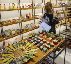 Shopping inside tourist souvenir craft shop selling pottery and ceramics, Guimaraes, northern