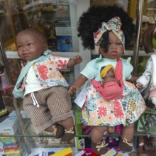 Black skinned baby dolls on display in shop window, city of Guimaraes, northern Portugal
