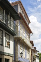 Street of historic buildings with balconies, Rua Egas Montiz, city centre Guimaraes, northern