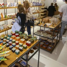 Shopping inside tourist souvenir craft shop selling pottery and ceramics, Guimaraes, northern