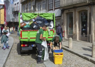 Waste refuse collection service in city centre street, Guimaraes, northern Portugal