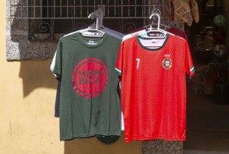 Super Bock brand t-shirt and replica national football shirt on display outside shop, Guimaraes,