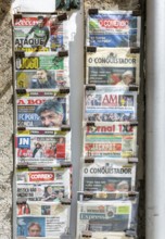Rack of newspapers on display outside newsagent shop, city of Guimaraes, Portugal, Europe