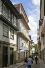 Street of historic buildings with balconies, Rua Egas Montiz, city centre Guimaraes, northern