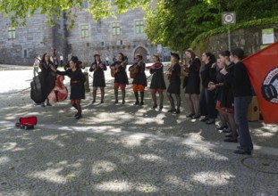 Group female university students musicians perform in street, city of Guimaraes, northern Portugal