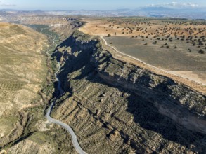 Deep canyon at the Gorafe desert, winding road to village Gorafe, aerial view, Gorafe Desert,