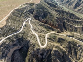Canyons and gorges near village Gorafe, winding road, aerial view, Gorafe Desert, UNESCO Granada